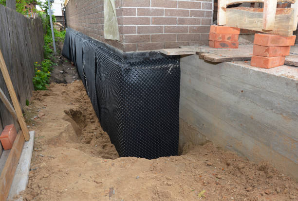 Happy homeowners after waterproofing job in Brokaw